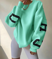 mintgroene oversized sweatshirt met zwarte CHICAGO NEW YORK opdruk op mouwen