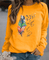 Sweatshirt Drinna hivernal pour femme avec détails plume, coupe confortable et doublure douce adaptée aux journées froides.